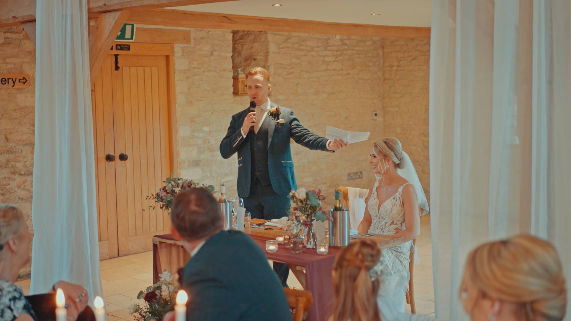  Best man giving a wedding speech while holding a paper — a memorable and emotional moment to capture in your wedding video by a Somerset wedding videographer