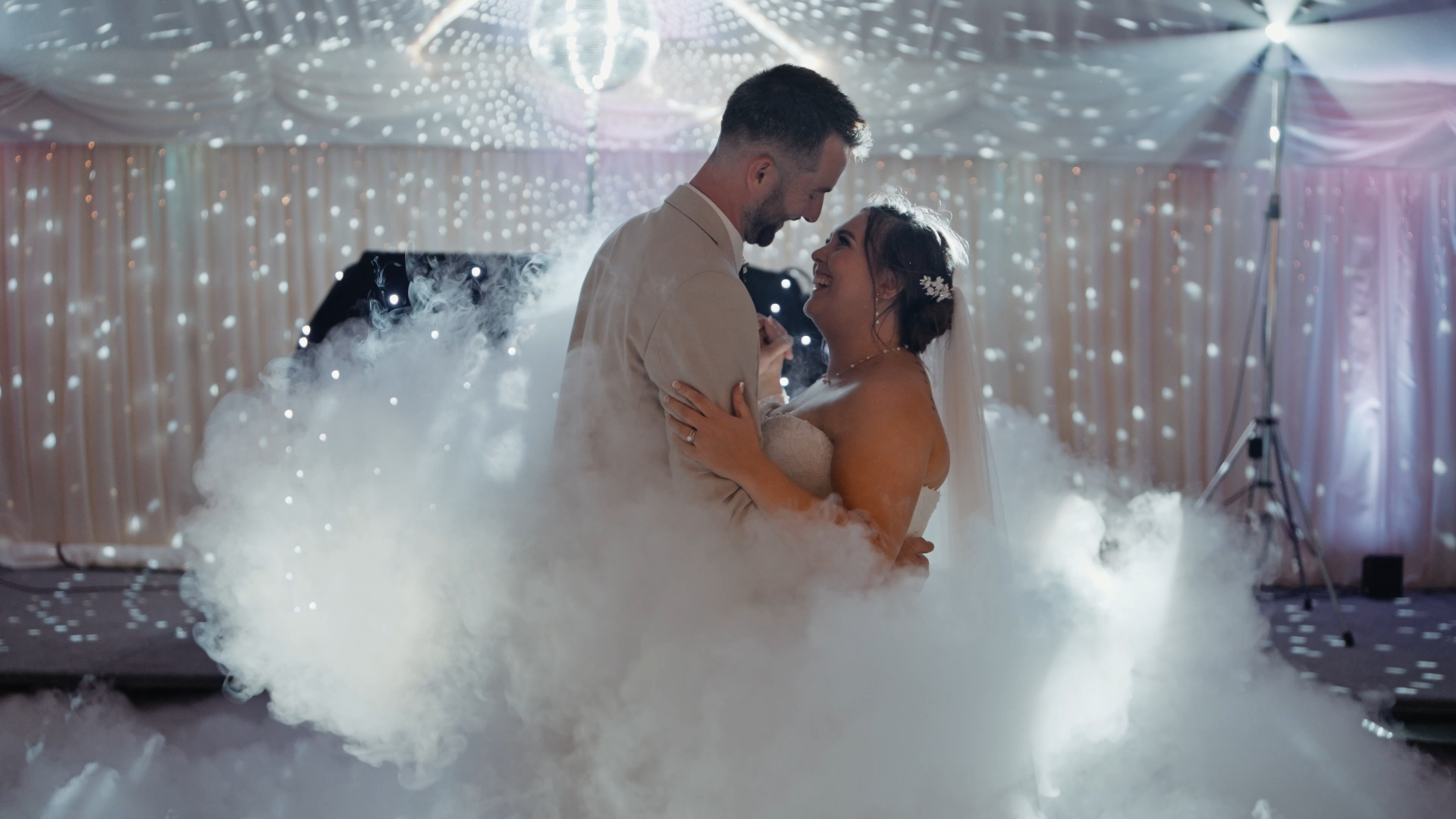 Bride and groom dancing surrounded by a smoke effect