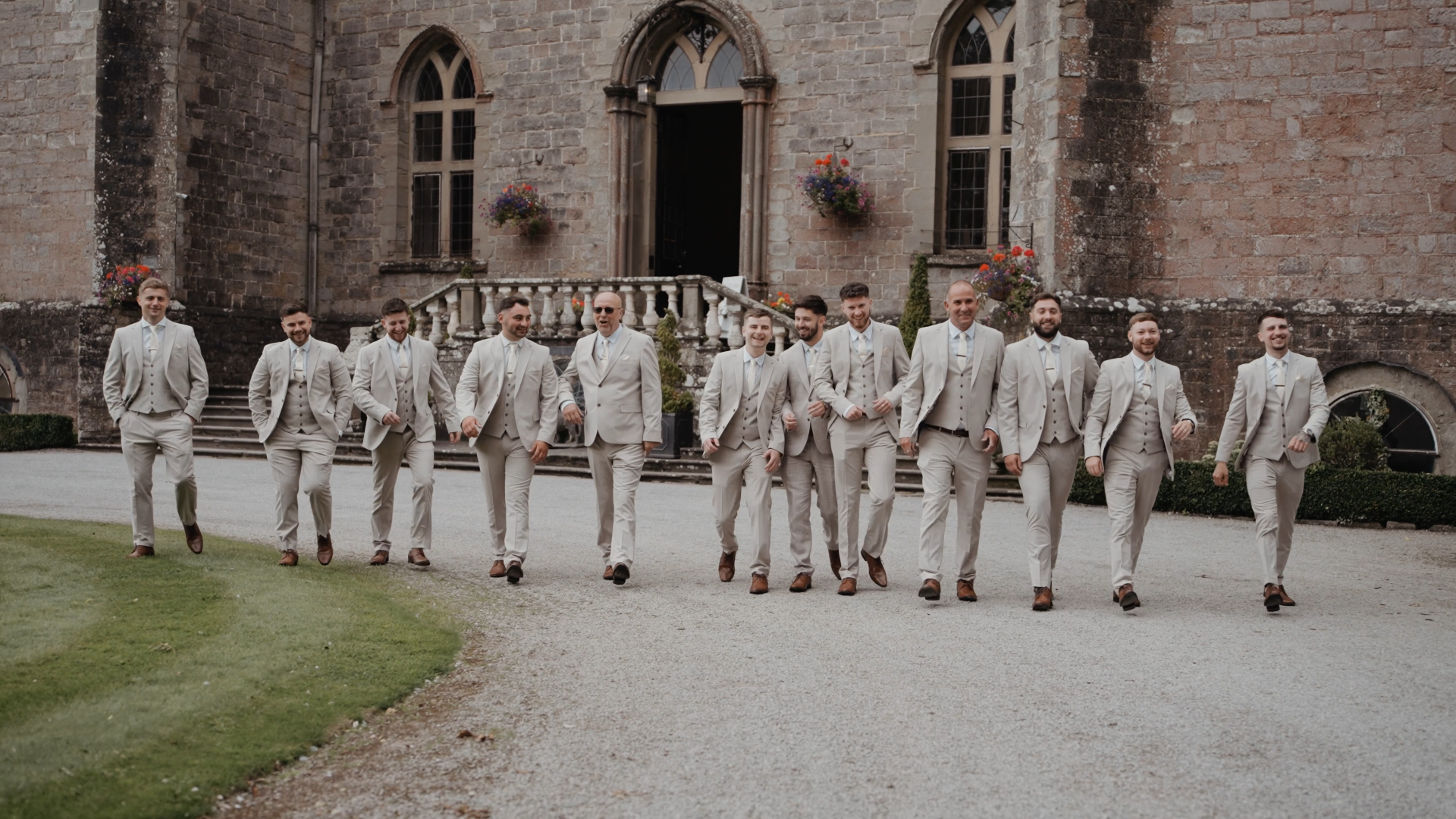 Groom and his groomsmen, all dressed in trendy mocha suits, one of the hot wedding trends in 2025, walking together in style towards the ceremony—capturing the modern and coordinated look of the bridal party.