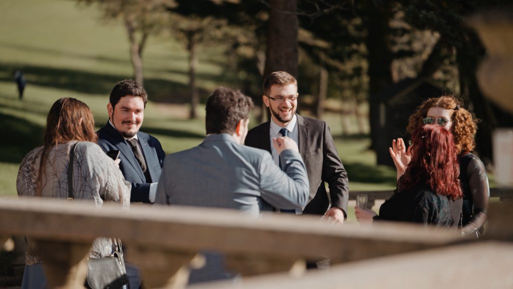 Groom happily greeting wedding guests — a warm and genuine moment to capture in your wedding video by a Somerset wedding videographer