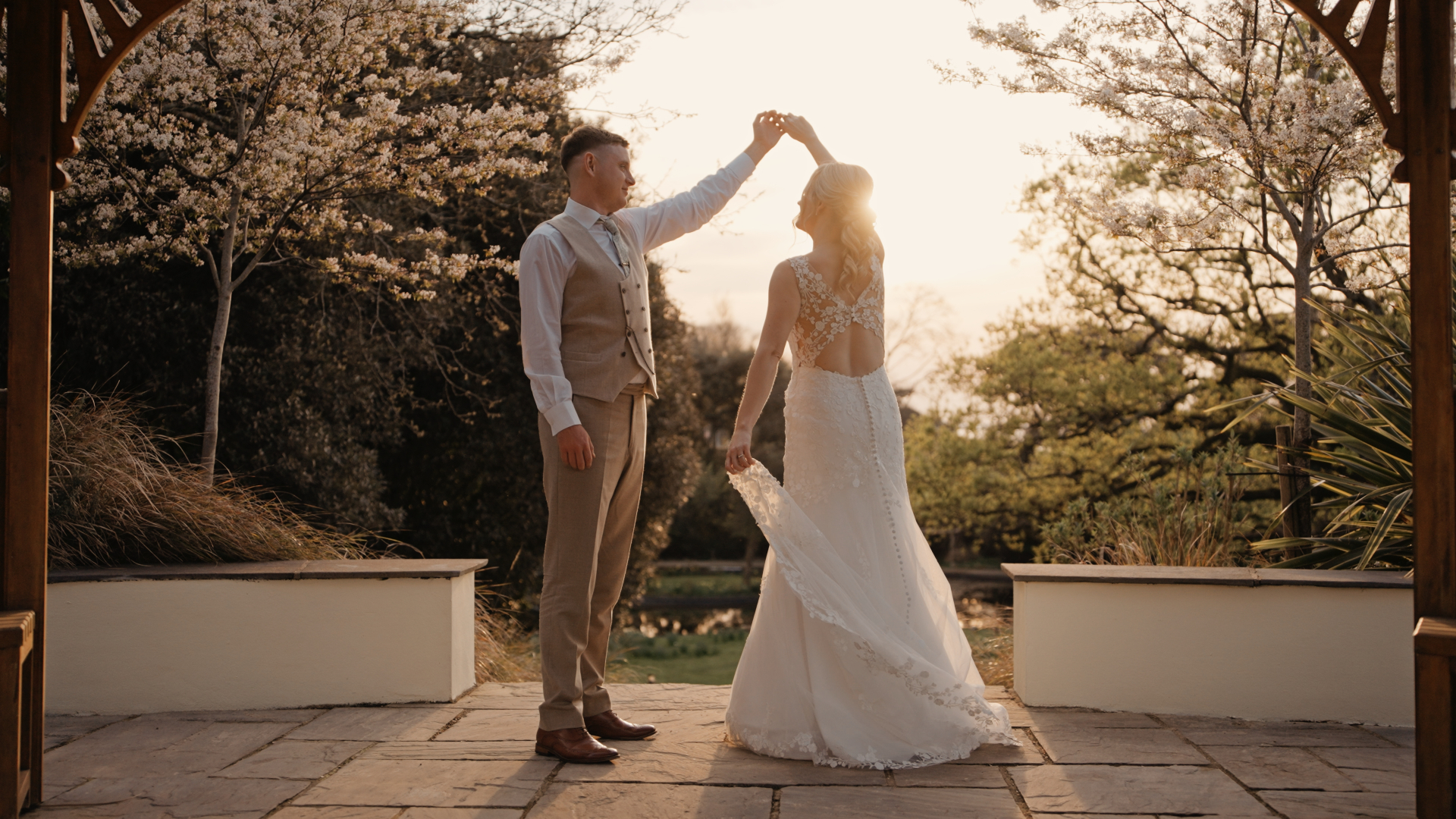 Groom spinning the bride during golden hour — a dreamy and romantic moment to capture in your wedding video by a Somerset wedding videographer