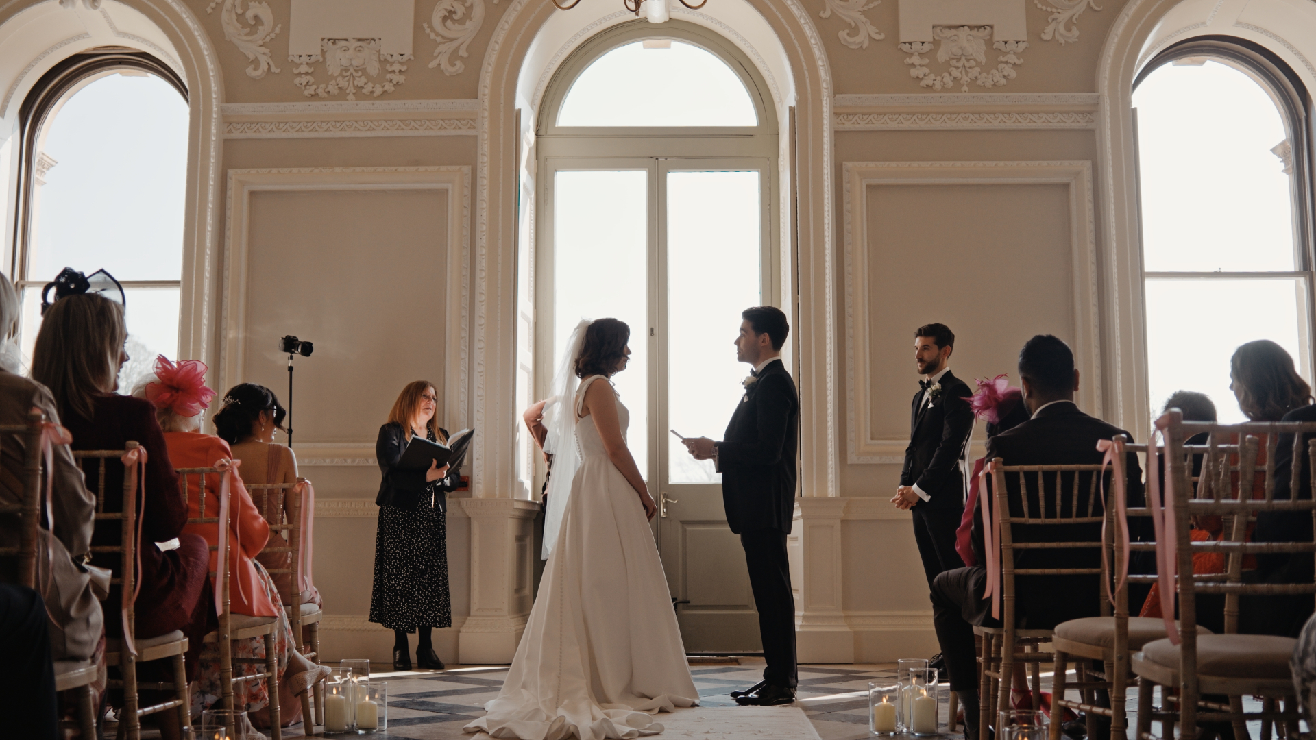 The groom reads his heartfelt vows to the bride during the ceremony, capturing an emotional and intimate moment for their wedding video.