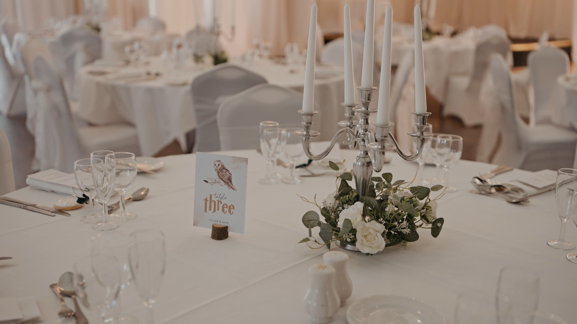 A Harry Potter-themed table number card displayed on a reception table, featuring magical design elements that highlight the couple’s unique decorative wedding details.