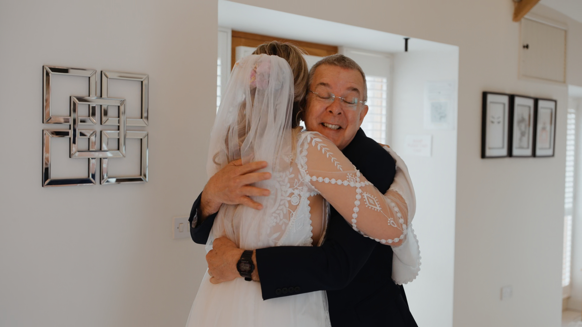 Father of the bride hugging his daughter emotionally, a heartfelt moment captured in a wedding video package.