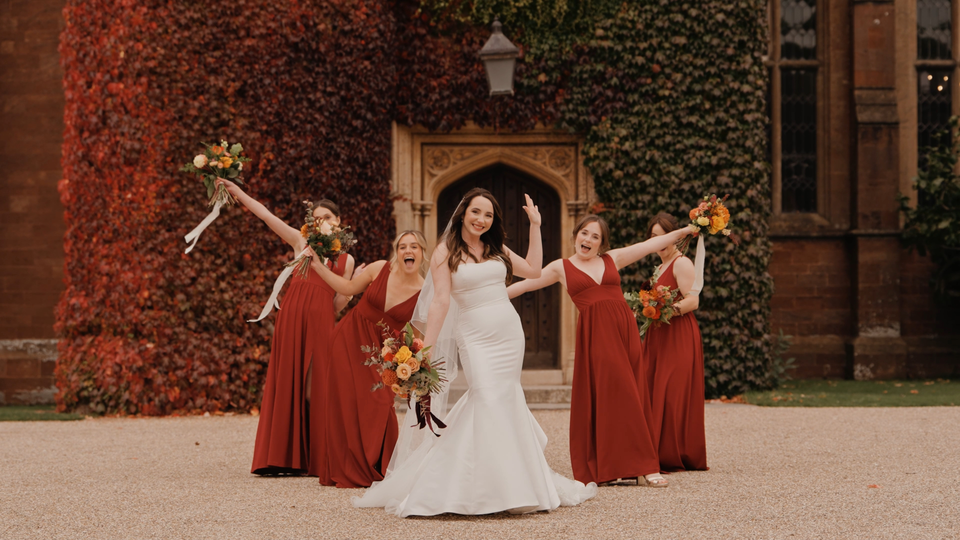 Bridal party dressed in burnt orange gowns, showcasing stylish autumn wedding styling tips.