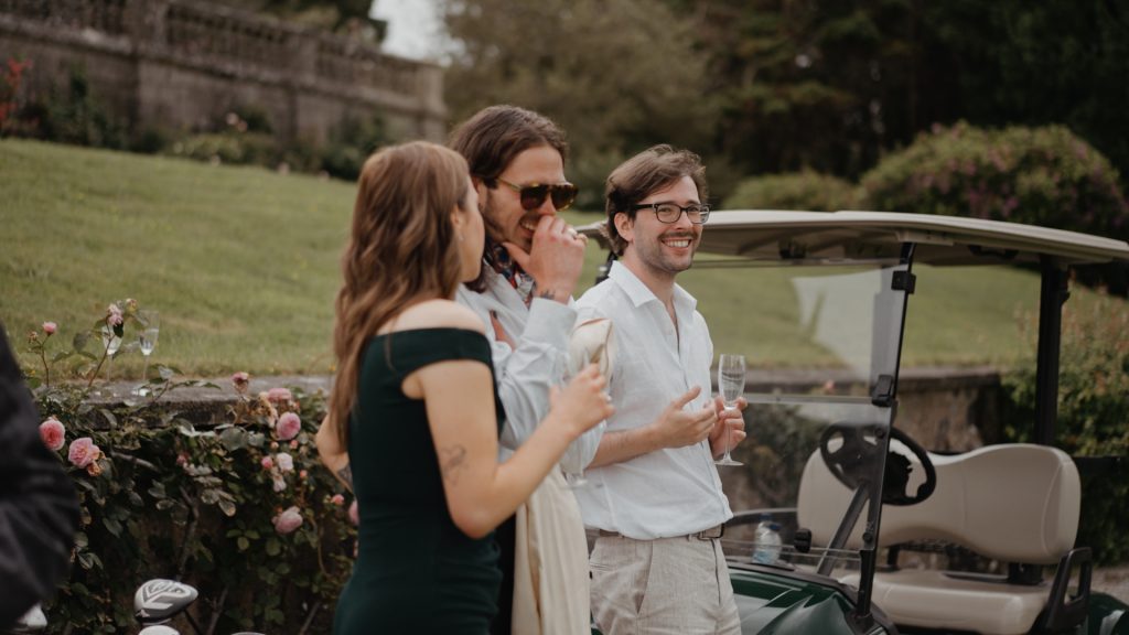 Wedding guests enjoying champagne and scenic views during a golf game