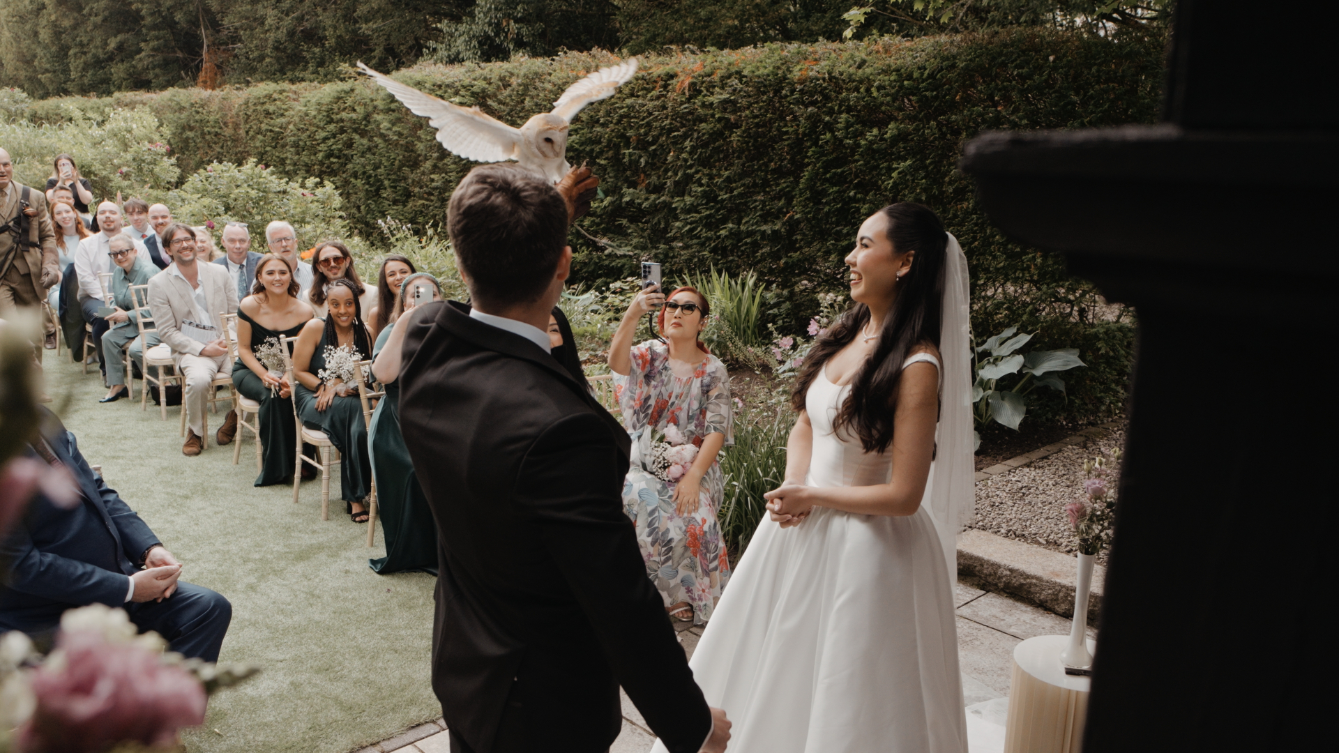 Bride and groom exchanging vows as an owl delivers the wedding rings at the ceremony