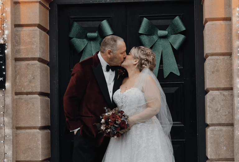 Bride and groom share a romantic kiss outside Holbrook Manor and Spa on their wedding day.