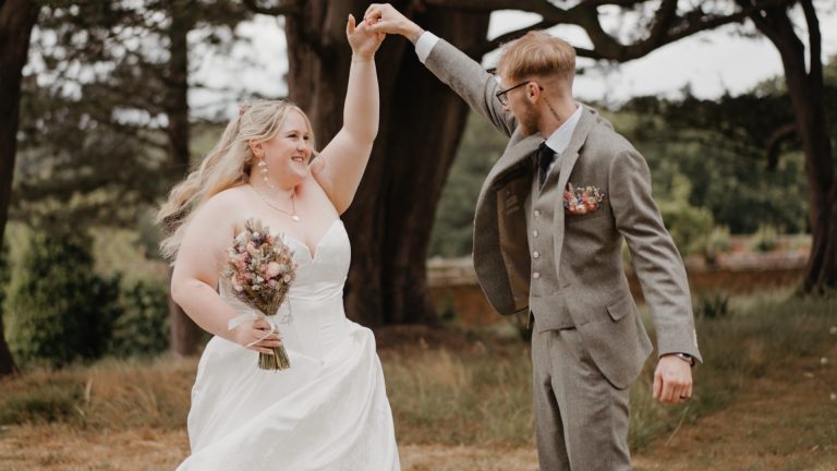 Bride and groom deeply in love, sharing an intimate slow dance as the groom gently spins the bride at The Pig Hotel.