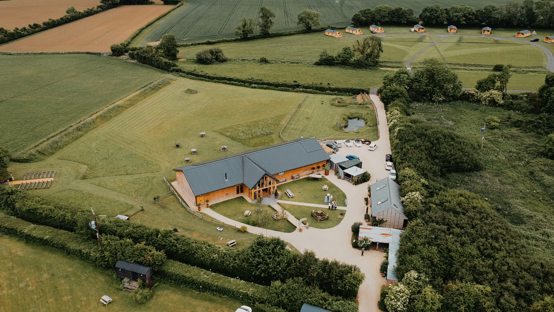 Aerial view of Old Oak Farm showcasing its lush green landscape and rustic architecture in the Somerset countryside.