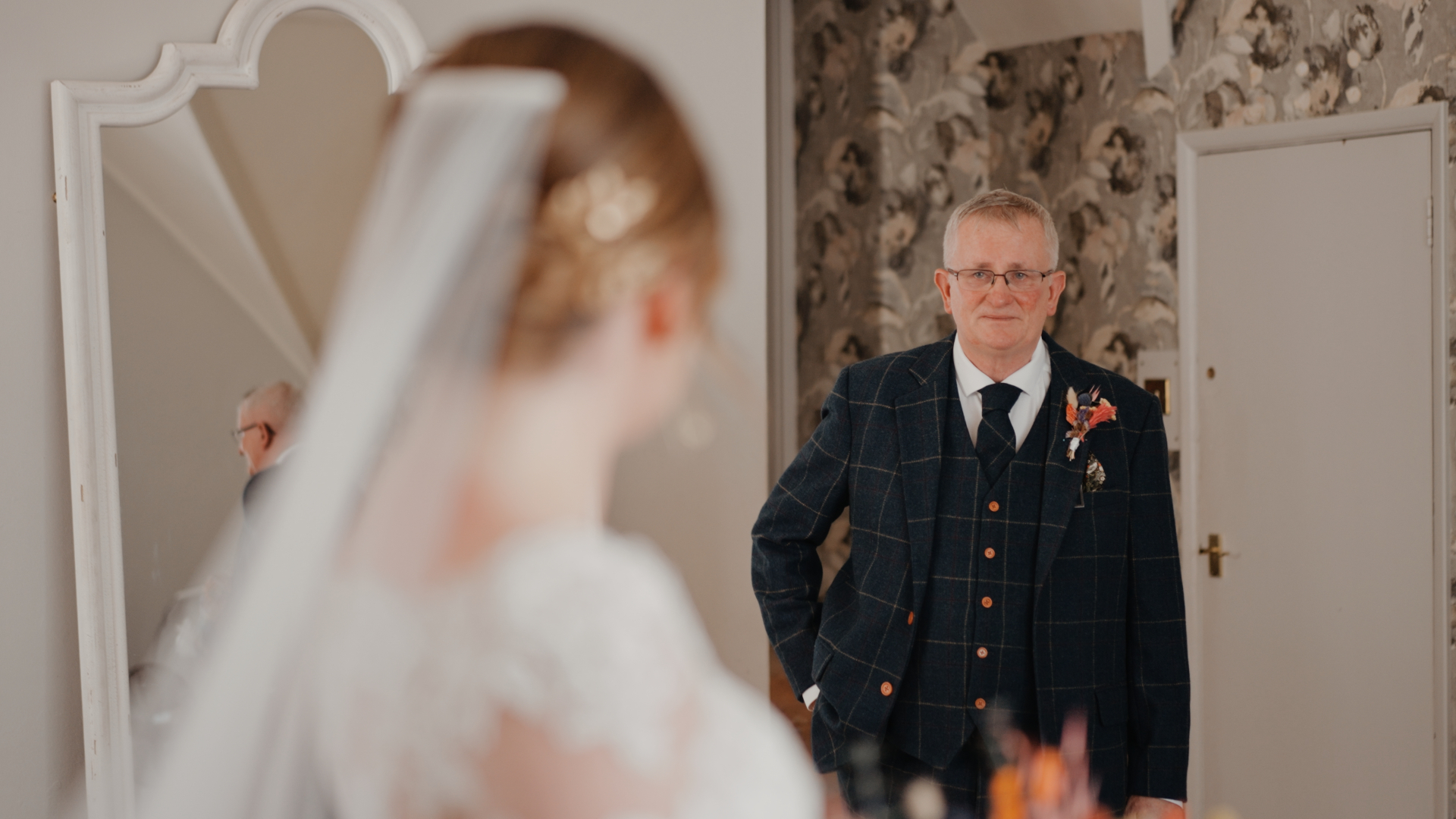 An emotional first look as the bride’s father sees her in her wedding dress before walking her down the aisle.