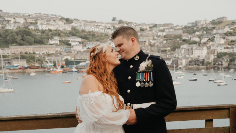 Bride and groom share a romantic moment overlooking the sea at Harbour Hotel Fowey.