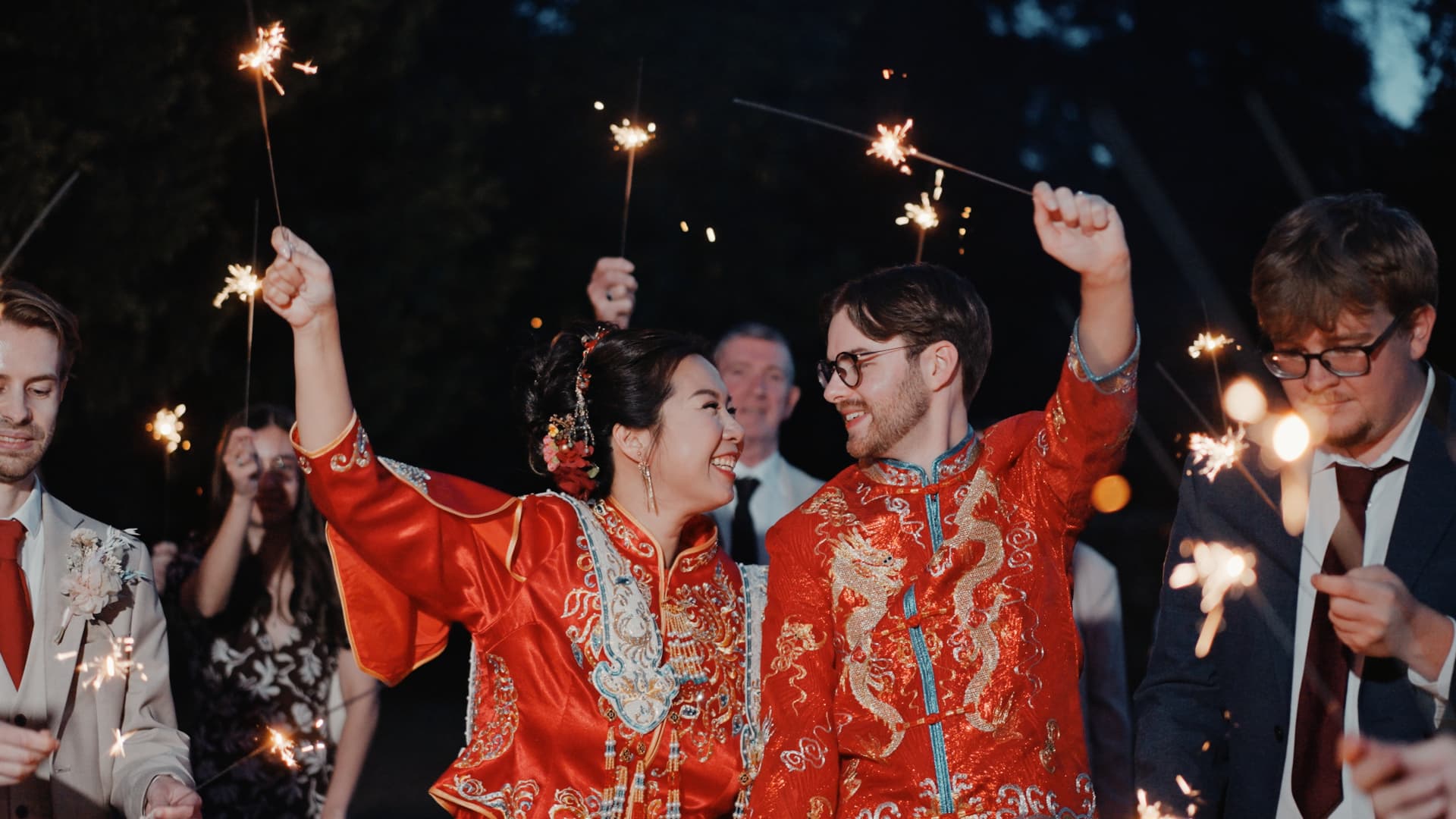 Sparklers lighting up the night as the couple celebrate with guests during their Holmewood Hall wedding.