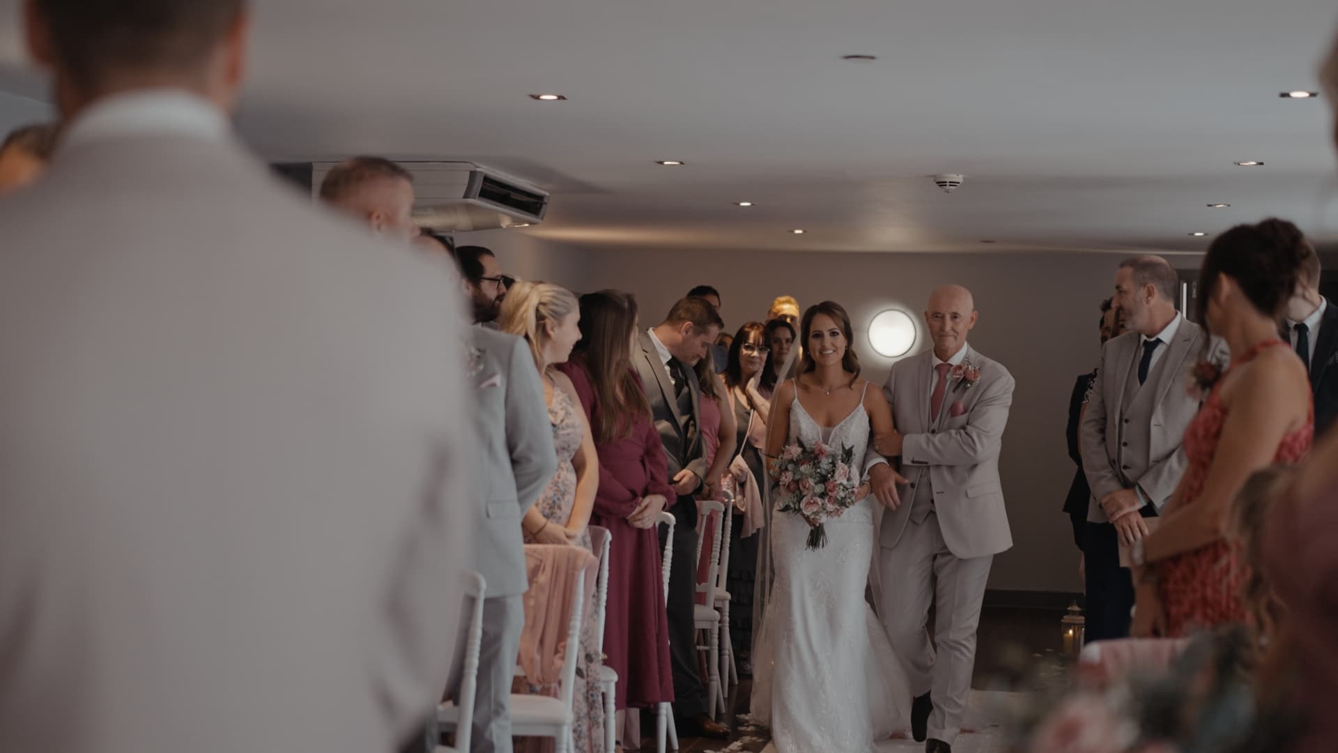 Bride walking down the aisle with her father at a Cadbury House Wedding ceremony.