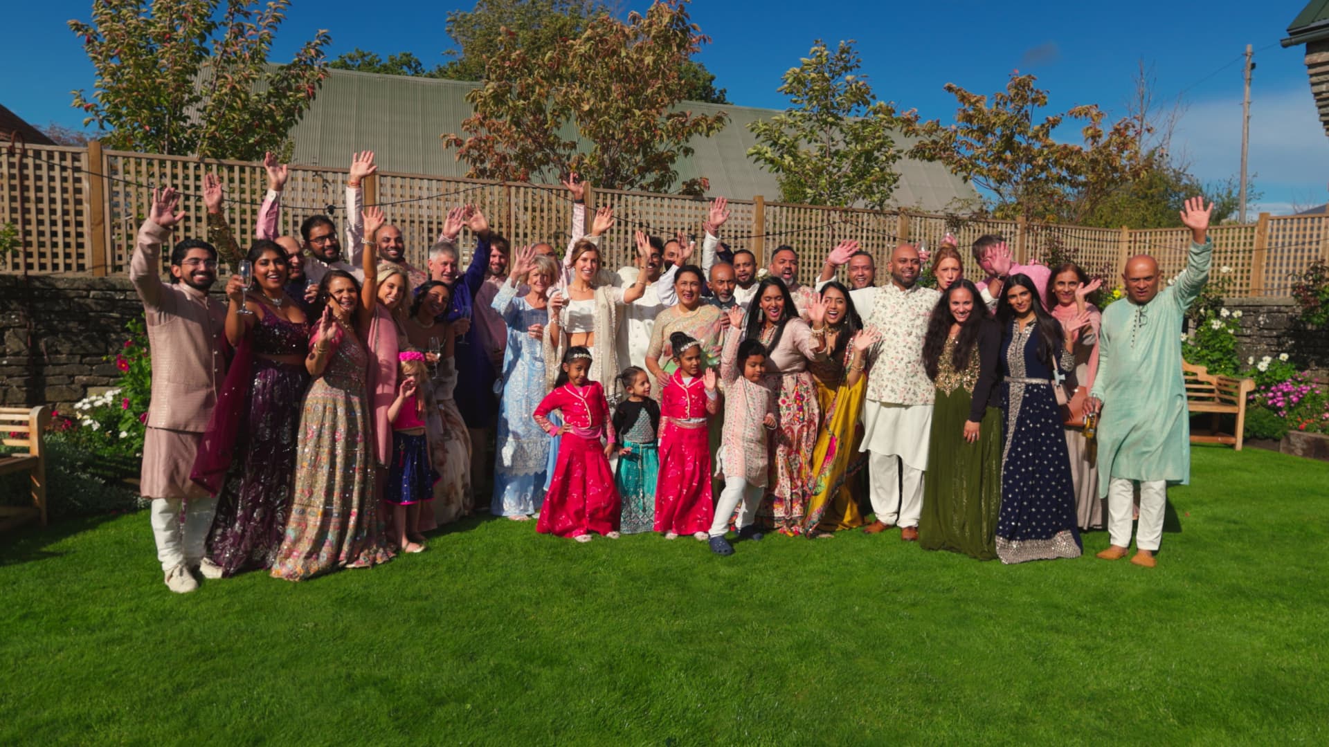 Wedding guests celebrating together outdoors at Naas Court Farm, captured naturally by a wedding videographer during a joyful rustic barn wedding.