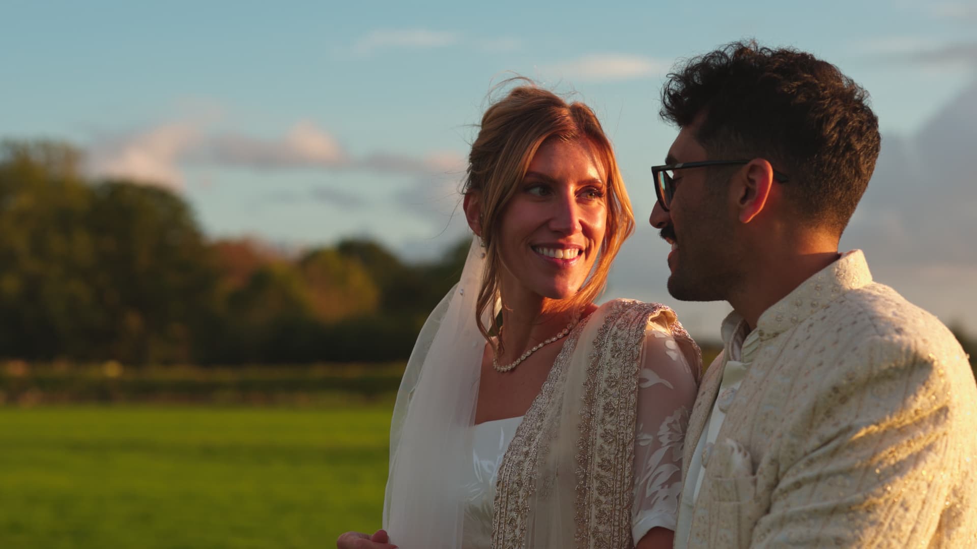 Katie and Shaunak sharing a relaxed sunset moment together during their Naas Court Farm Wedding, captured naturally in the countryside setting.