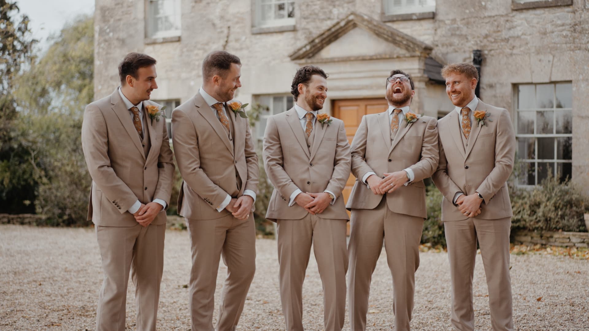 Groom and groomsmen sharing laughter before the ceremony, candidly filmed by a Wedding Videographer