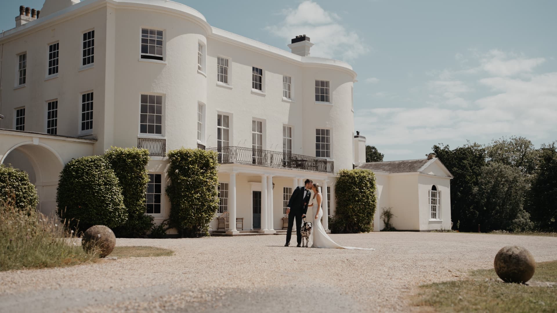 Bride and groom portrait outside Rockbeare Manor, a luxury Devon wedding venue, filmed by a Devon wedding filmmaker in a cinematic wedding film style