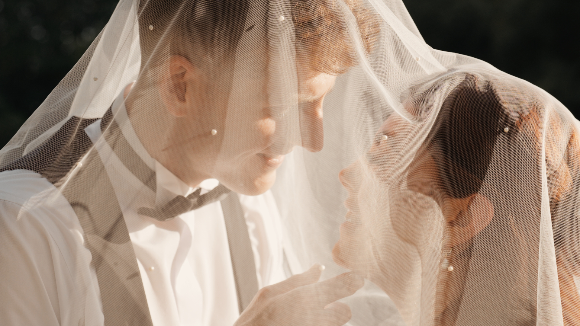 Intimate veil portrait of couple at Llanerch Vineyard in South Wales, softly lit and captured by a wedding filmmaker in a cinematic documentary style wedding film