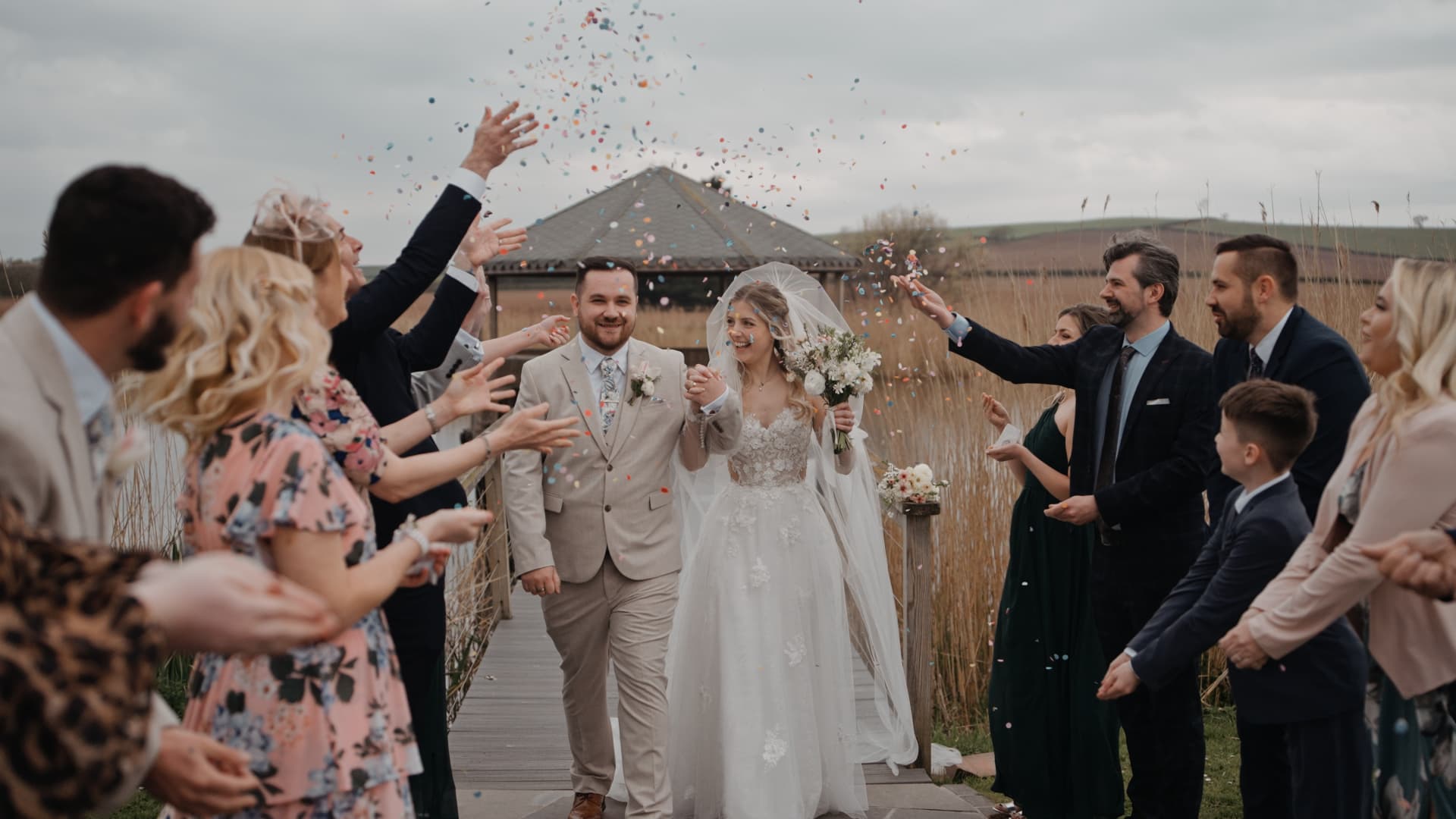 Confetti moment at Quantock Lakes wedding in Somerset, full of joy and movement, captured through authentic wedding videography with a luxury documentary wedding film approach.