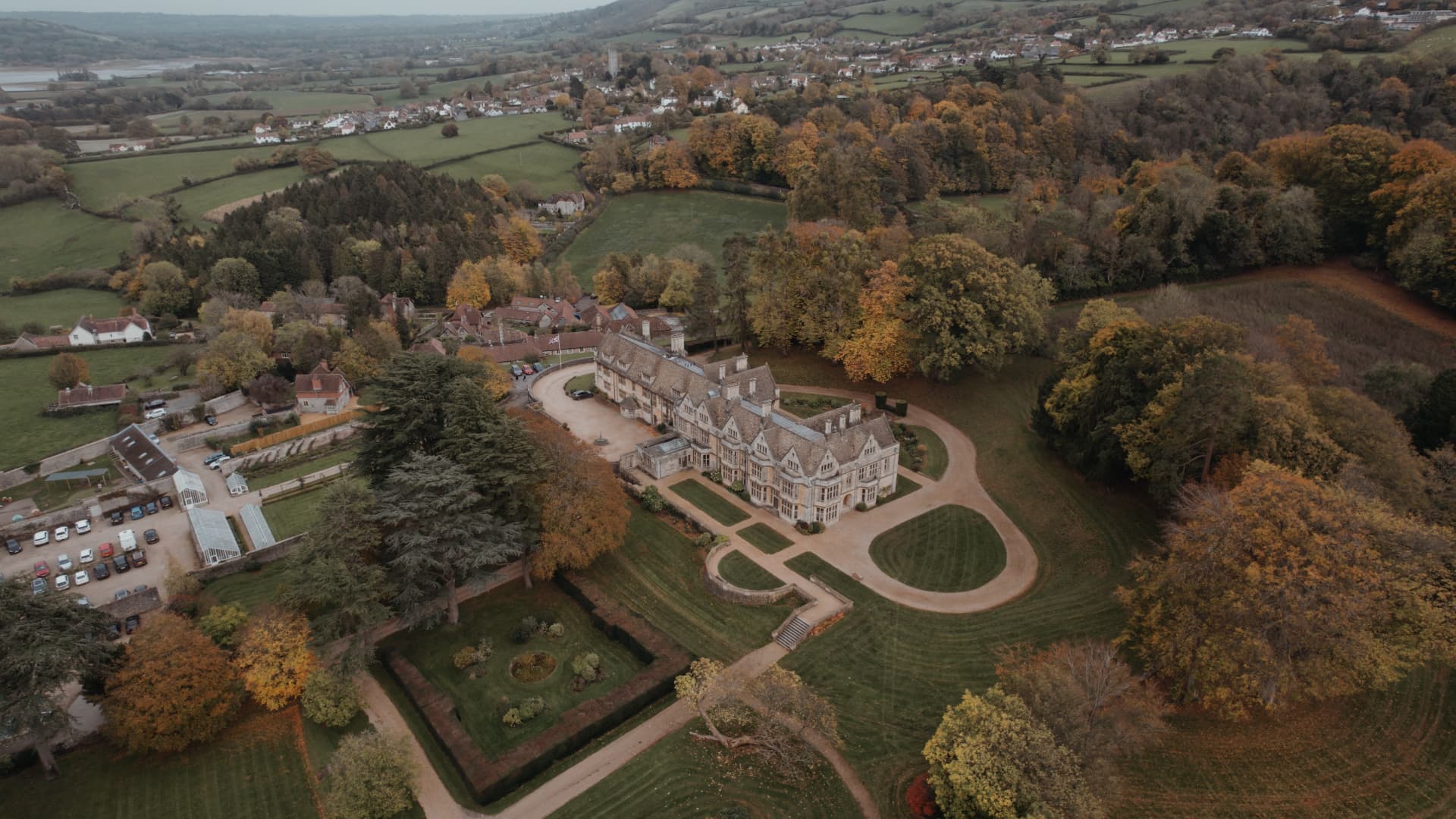 Aerial drone view of Coombe Lodge Blagdon showcasing the elegant country house, landscaped grounds and surrounding Somerset countryside during a beautiful wedding day.