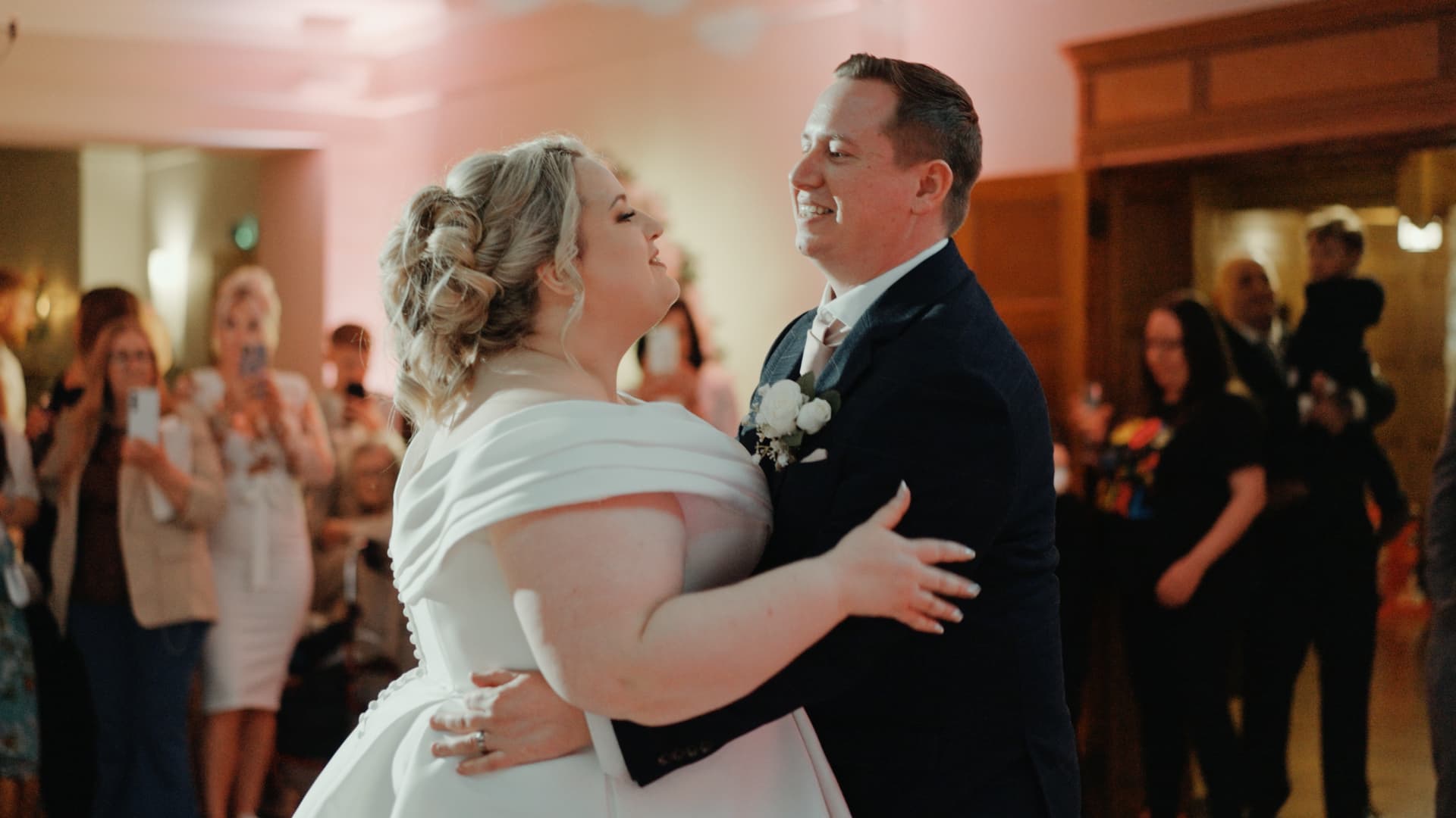 Bride and groom sharing a romantic first dance surrounded by loved ones, captured through wedding videography at Coombe Lodge Blagdon.