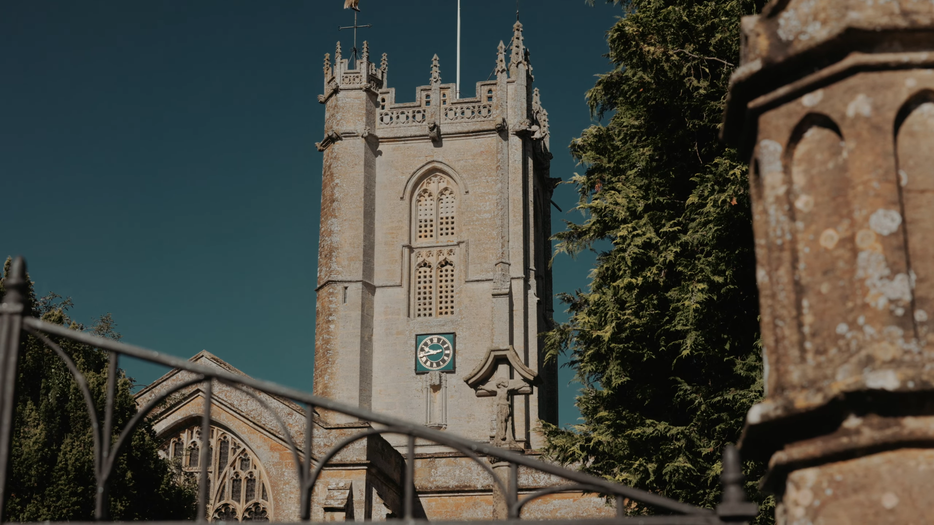 Historic stone tower of St George's Church in Hinton St George, Somerset, on a sunny wedding day